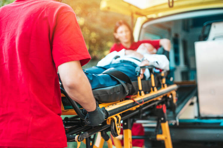 A pedestrian being loaded into an ambulance realizing they need a accident lawyer